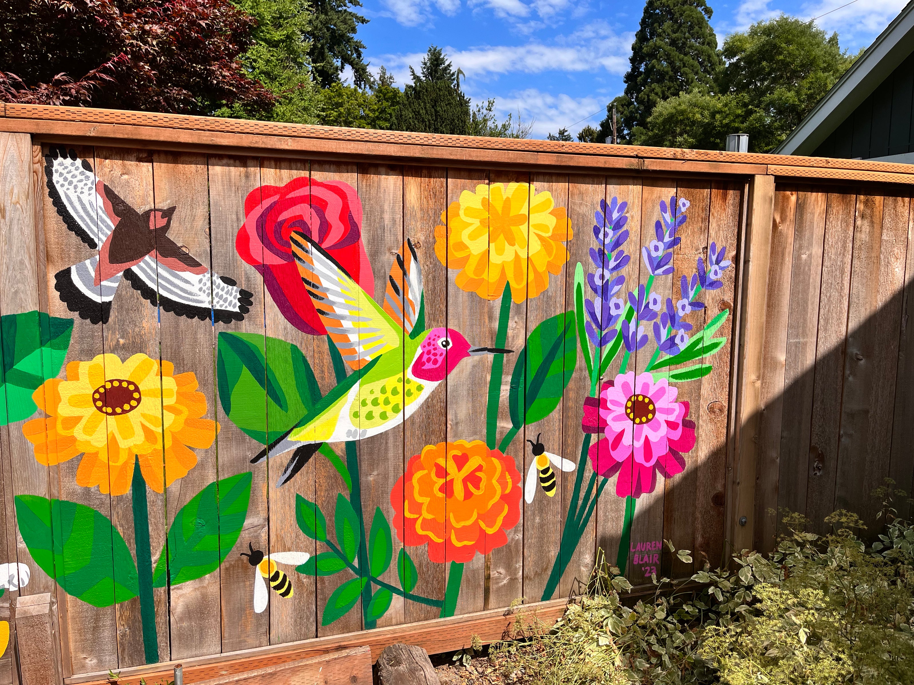 Mural of wildflowers, hummingbird, and honeybees