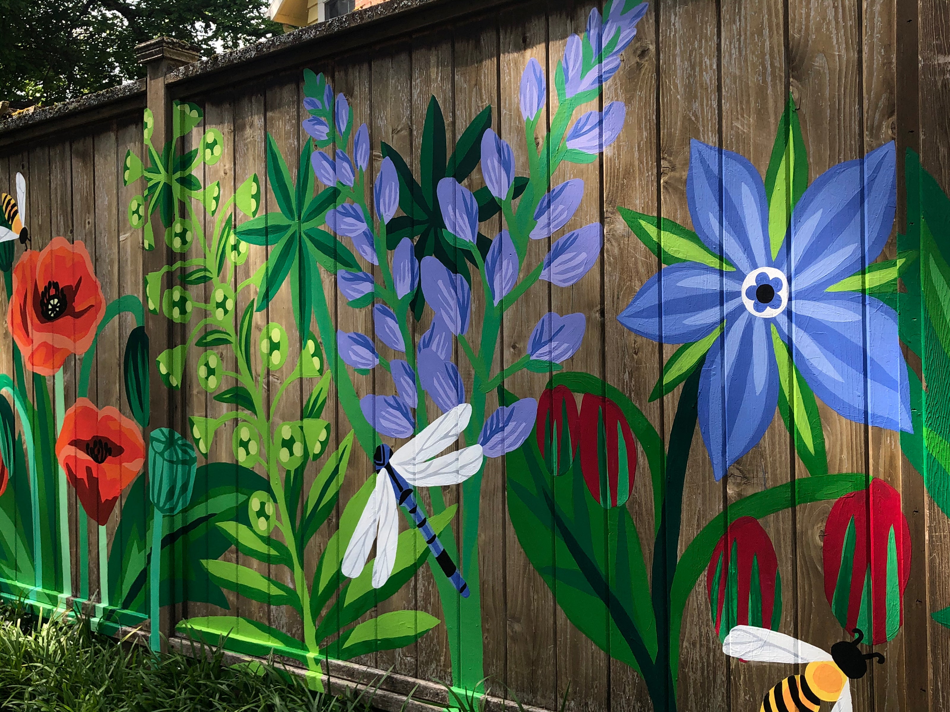 Wildflowers mural on a fence with dragonflies and bees