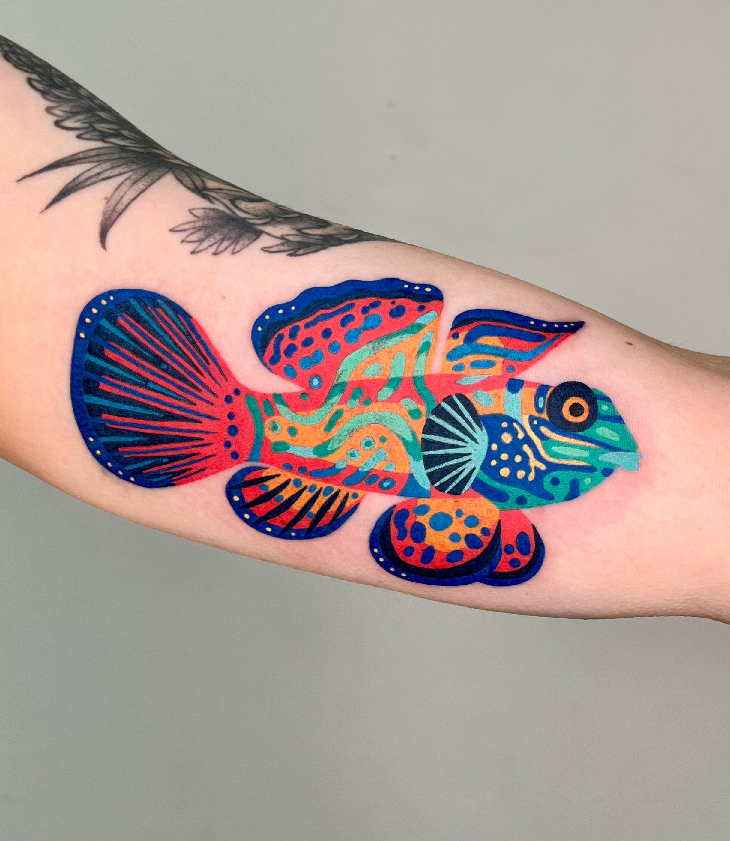 Mandarinfish colorful tattoo on arm