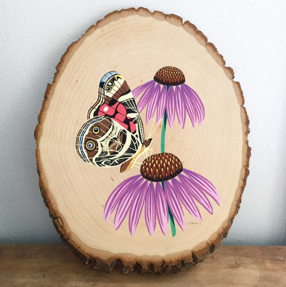 Painting done on wood of a moth on flowers
